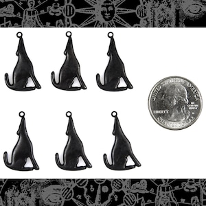 May include: Six black metal wolf charms, each about the size of a US quarter. The charms are in the shape of a wolf howling at the moon.