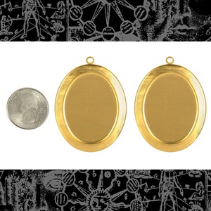 May include: Two gold-coloured oval pendants with a quarter for size comparison. Each pendant has a loop at the top for hanging. The pendants are set against a white background with black and grey illustrations at the top and bottom.