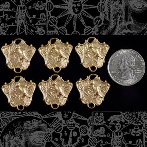 May include: Six gold-toned metal charms featuring a bird perched on a branch. Each charm has two holes for attaching to a chain or bracelet. The charms are arranged in two rows of three, with a quarter dollar coin for scale.