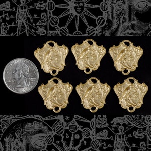 May include: Six gold-toned metal charms featuring a bird perched on a branch. Each charm has two holes for attaching to a necklace or bracelet.