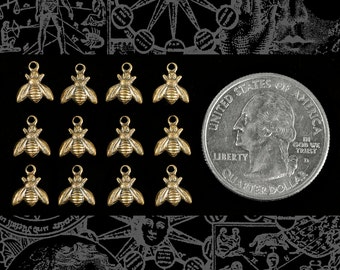 May include: Twelve gold-toned bee charms with a textured surface. The charms are arranged in four rows of three. A US quarter is included for size reference.