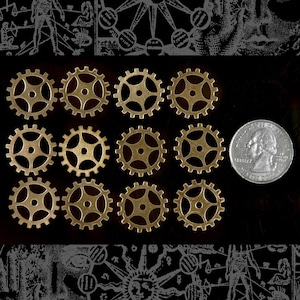 May include: Twelve gold-colored metal gears of various sizes, arranged in three rows of four, on a black background. A silver quarter is in the upper right corner of the image.