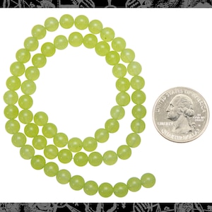 May include: A strand of light green jade beads, approximately the size of a US quarter.