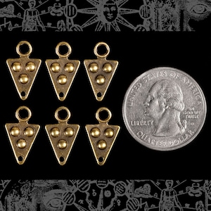 May include: Six antique gold-toned metal triangle pendant charms with three round accents on each charm. The charms are approximately the size of a US quarter.