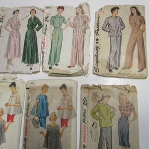May include: A collection of vintage sewing patterns featuring various clothing designs. The patterns are printed on paper and include instructions and diagrams for creating garments. The patterns are from Simplicity and include sizes and prices.