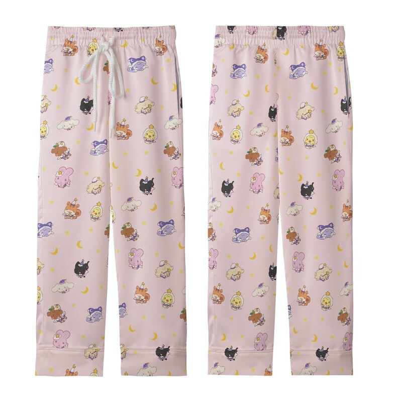 May include: Pink pajama pants with an all-over print of cartoon characters, moons, and clouds. The pants have a drawstring waist and a relaxed fit. The fabric appears to be a soft, lightweight material.