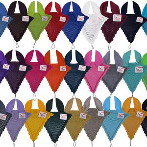 May include: A collection of crocheted baby blankets in various colors, including blue, green, and pink. Each blanket has a unique scalloped edge and a matching hood. The blankets are displayed with a tag attached.