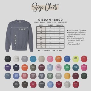 May include: A size chart for a Gildan 18000 heavy blend crewneck sweatshirt, with chest and length measurements in inches. The chart includes sizes XS to 5XL. Below the chart are color swatches, including black, white, and navy.