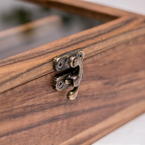 Close-up of walnut wood glasses holder with metal clasp