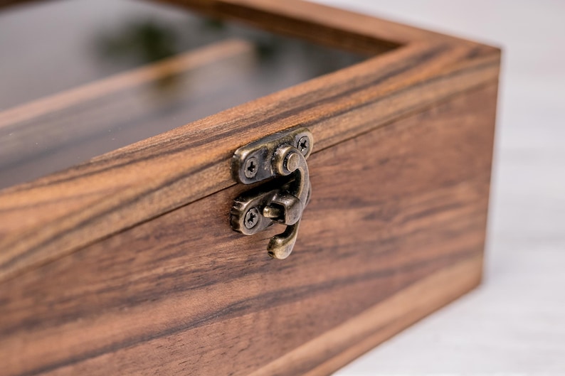 Close-up of walnut wood glasses holder with metal clasp