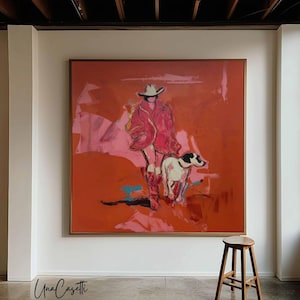 May include: A large square painting in a wooden frame featuring an abstract depiction of a person wearing a cowboy hat and boots walking with a dog. The artwork uses a vibrant palette of deep orange, bright pink, and touches of blue and black.