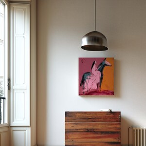 May include: An abstract painting of a figure on a horse in pink and blue hangs above a wooden chest of drawers. The room has a large window with white shutters and a silver pendant light.