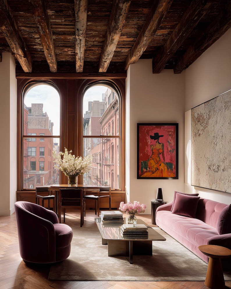 May include: A luxurious living room with a mauve velvet sofa, a matching armchair, and a glass coffee table. The room features large arched windows, a wooden ceiling with exposed beams, and a colorful painting on the wall. A rug covers the floor.