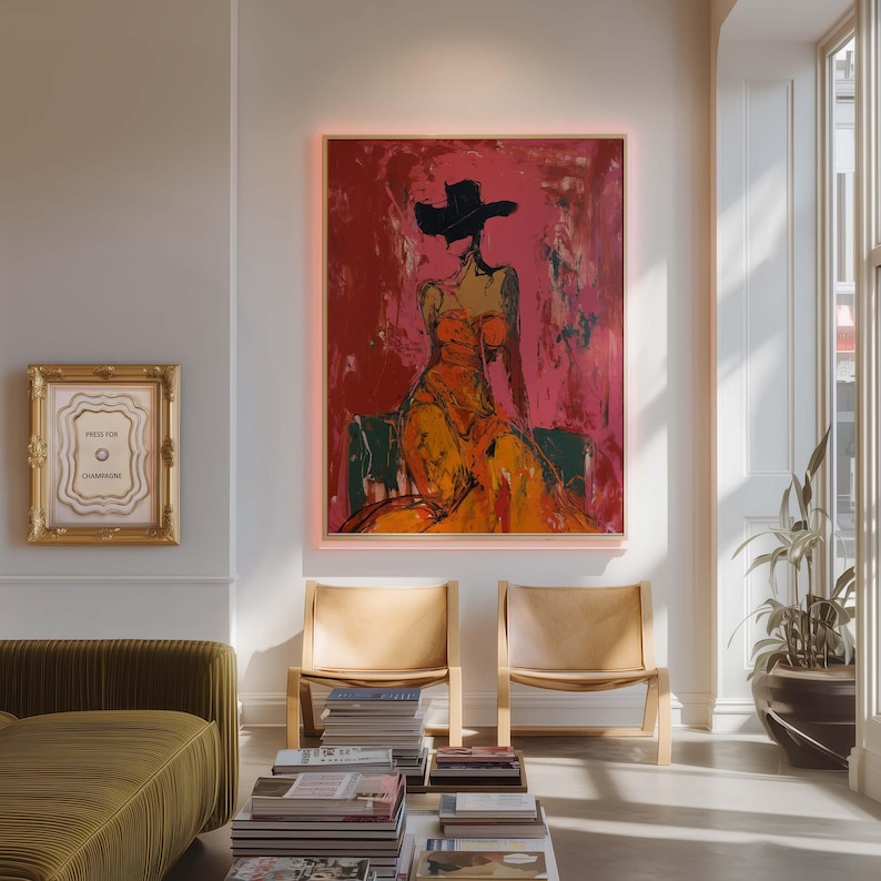 May include: An abstract painting of a woman in an orange dress and black hat against a red background. The artwork is framed and hangs above two wooden chairs. A smaller framed piece with the text "PRESS FOR CHAMPAGNE" is also visible.