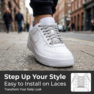 May include: White leather sneaker with gray laces and a silver "Custom" lace charm. The shoe features the Nike swoosh logo and is worn on a city street. Text on the image reads "Step Up Your Style, Easy to Install on Laces, Transform Your Daily Look."