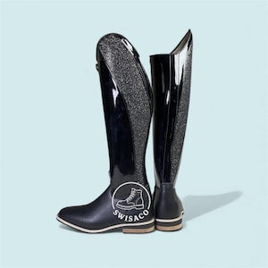 May include: Pair of black riding boots with a glossy finish and glitter detailing on the back. The boots have a streamlined design with a logo on the side and a light-coloured sole.