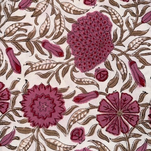 May include: A white fabric featuring a repeating floral pattern with dark pink blossoms and buds, accented by light brown, curved, leafy vines that intertwine across the surface in a dense, continuous botanical print design.
