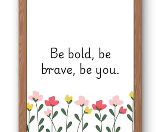 May include: A framed print with the text "Be bold, be brave, be you." The print features a floral border with pink, red, and yellow flowers. The frame is made of light brown wood.