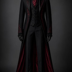 May include: A black formal suit with a long coat, vest, and trousers. The coat and vest feature intricate red floral embroidery. The coat's interior lining is a deep red. The suit is displayed on a mannequin with black gloves and shoes, set against a dark gray backdrop.