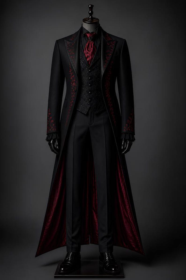 May include: A black formal suit with a long coat, vest, and trousers. The coat and vest feature intricate red floral embroidery. The coat's interior lining is a deep red. The suit is displayed on a mannequin with black gloves and shoes, set against a dark gray backdrop.