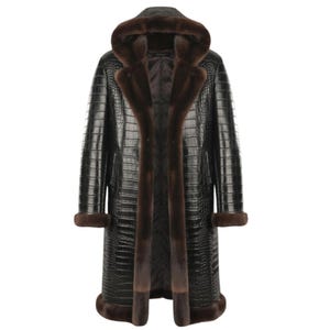 May include: A long black coat with a crocodile skin texture, featuring a hood and brown fur trim along the front, cuffs, and hood. The coat is a luxurious outerwear garment.