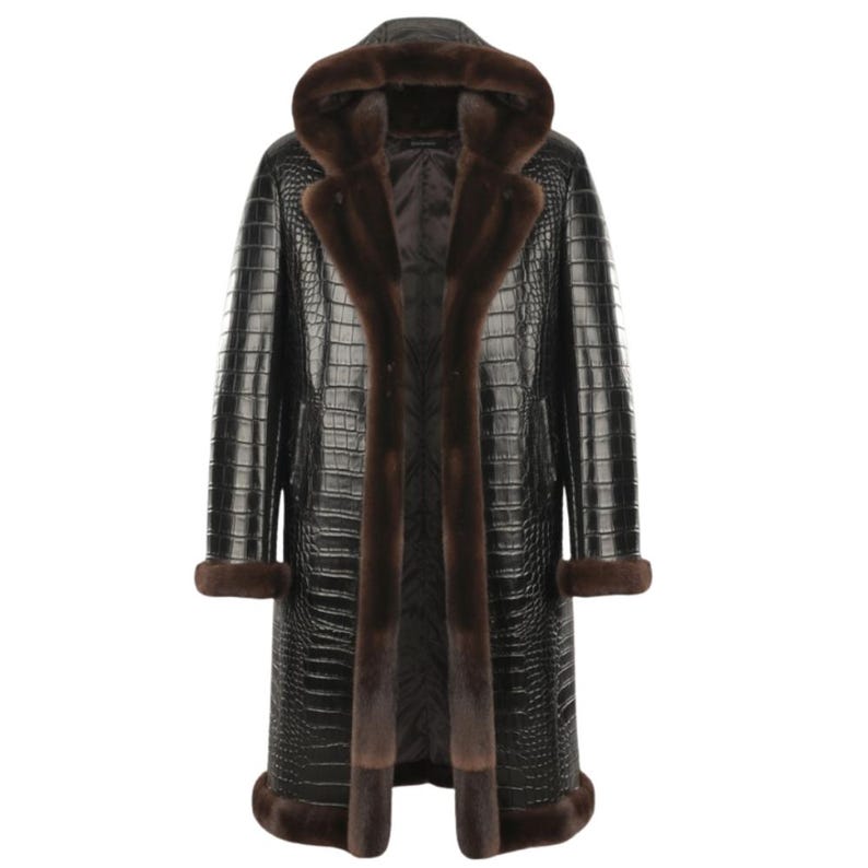May include: A long black coat with a crocodile skin texture, featuring a hood and brown fur trim along the front, cuffs, and hood. The coat is a luxurious outerwear garment.