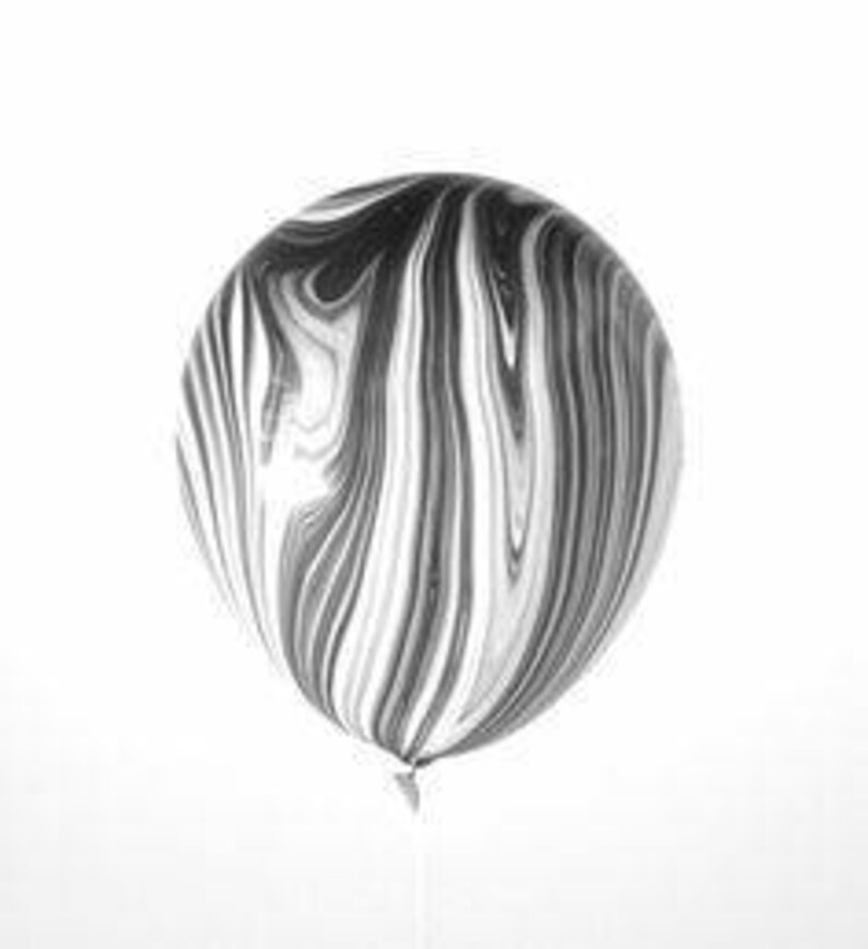 May include: A black and white marbled balloon.