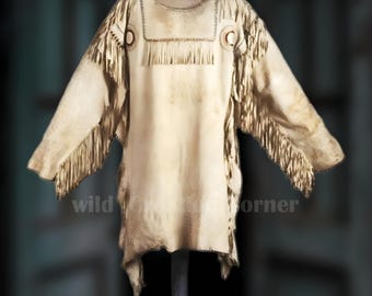 May include: Cream-colored, long-sleeved tunic with fringed accents. The tunic features decorative stitching around the neckline and shoulders, with fringe along the sleeves and upper chest. The garment has a rustic, vintage aesthetic.