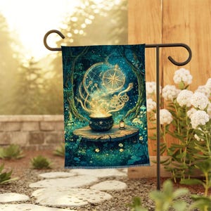 May include: A rectangular garden flag featuring a dark teal forest scene with a glowing golden cauldron on a tree stump. Above the cauldron, a celestial map with a compass rose and navigational tools emits light. A small lantern sits nearby.