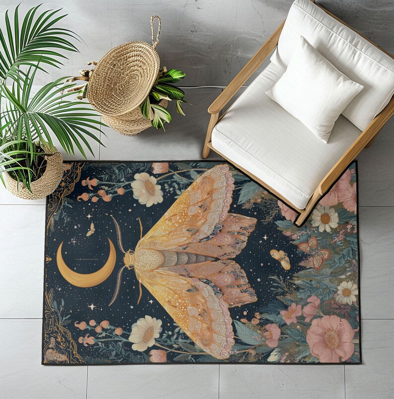 May include: A rectangular area rug featuring a large moth design with a crescent moon and floral elements. The rug has a dark blue background with a moth in shades of orange and pink. The rug is surrounded by flowers and greenery.