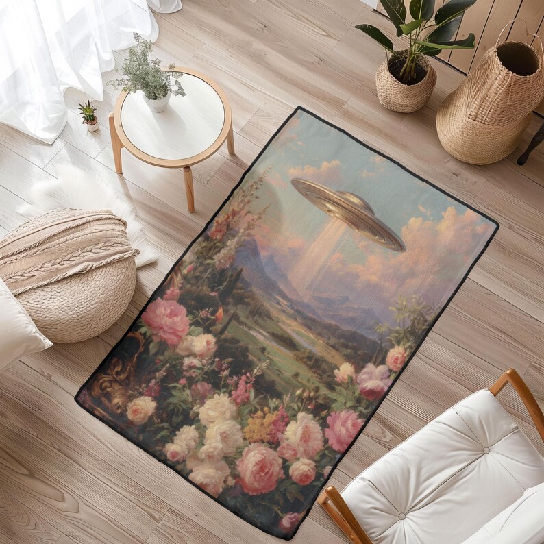 May include: Rectangular area rug featuring a surreal landscape with a vintage aesthetic. The design includes a flying saucer, a mountain range, and a vibrant floral border with pink and white roses. The rug has a black border.