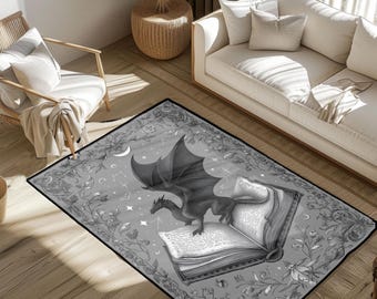 May include: A rectangular gray rug featuring a detailed illustration of a dragon perched atop an open book. The design includes celestial elements like stars and a crescent moon, with floral borders. The rug is suitable for living rooms and bedrooms.