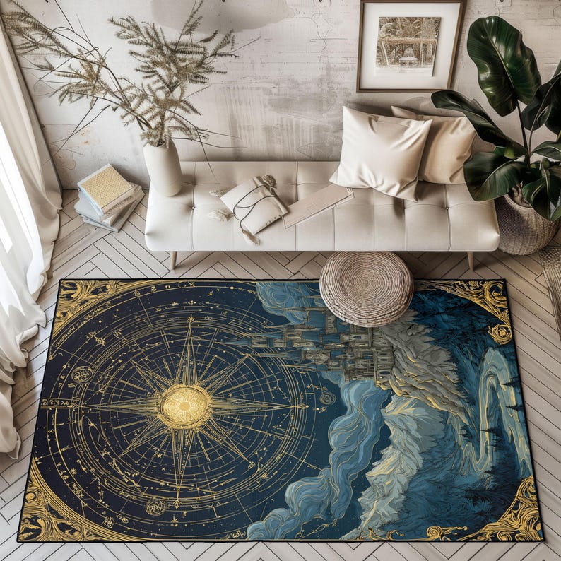 May include: A rectangular area rug with a celestial design. The rug features a compass rose in gold against a dark blue background, with a detailed illustration of a city and mountains. The rug is framed with a gold border.