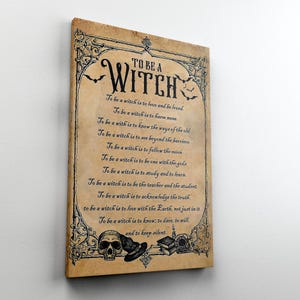 May include: A framed print with the text "TO BE A WITCH" in a gothic font, surrounded by decorative bats and scrollwork. The text includes a list of witch-related affirmations. The print has a vintage, aged paper appearance.