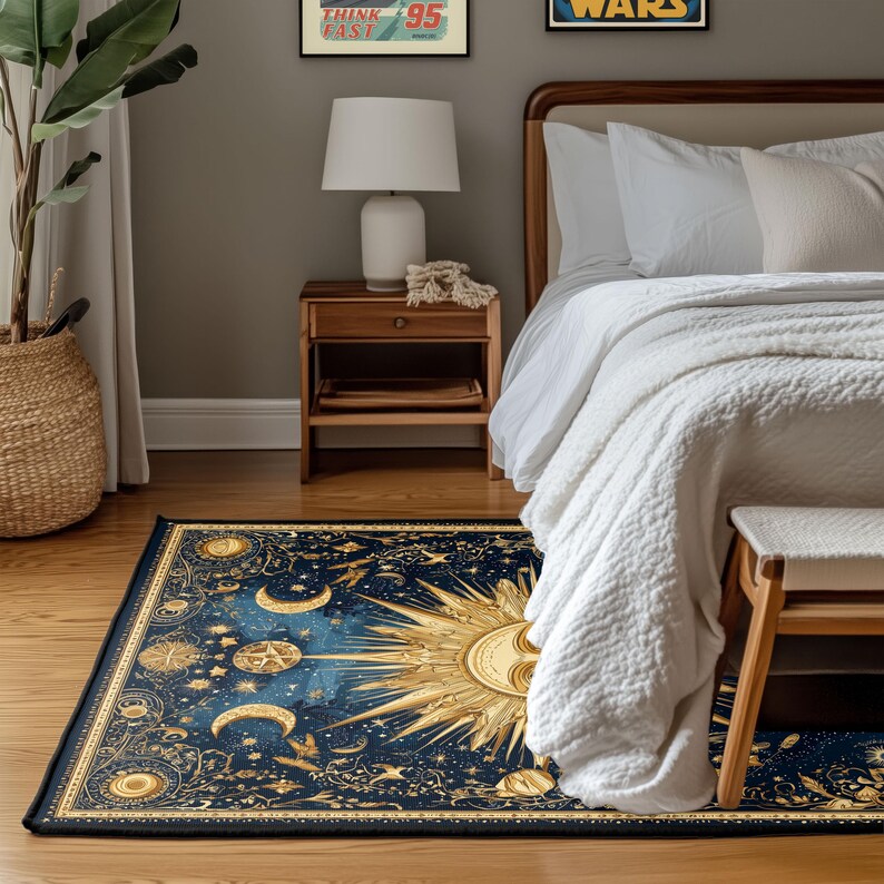 May include: A rectangular rug with a celestial design featuring a large sun, crescent moons, and stars in gold against a dark blue background. The rug is placed on a wooden floor in a bedroom setting, with a bed and nightstand visible.