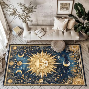 May include: A rectangular area rug with a celestial design. The rug features a large golden sun in the center, surrounded by moons, stars, and planets against a dark blue background. The rug has a detailed, ornate border.