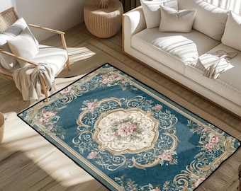May include: A rectangular area rug with a teal background and a floral design. The rug features a central medallion with pink flowers and gold scrollwork. The border is black.