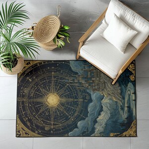 May include: A rectangular rug with a celestial map design. The rug features a large compass rose in gold against a dark blue background. The design includes constellations and a detailed illustration of a city and mountains.
