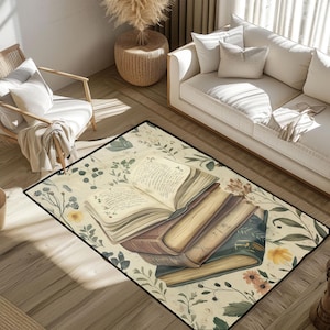 May include: A rectangular area rug featuring a stack of vintage books with open pages, surrounded by floral and botanical illustrations in soft, muted tones. The rug has a black border and is placed in a living room setting.