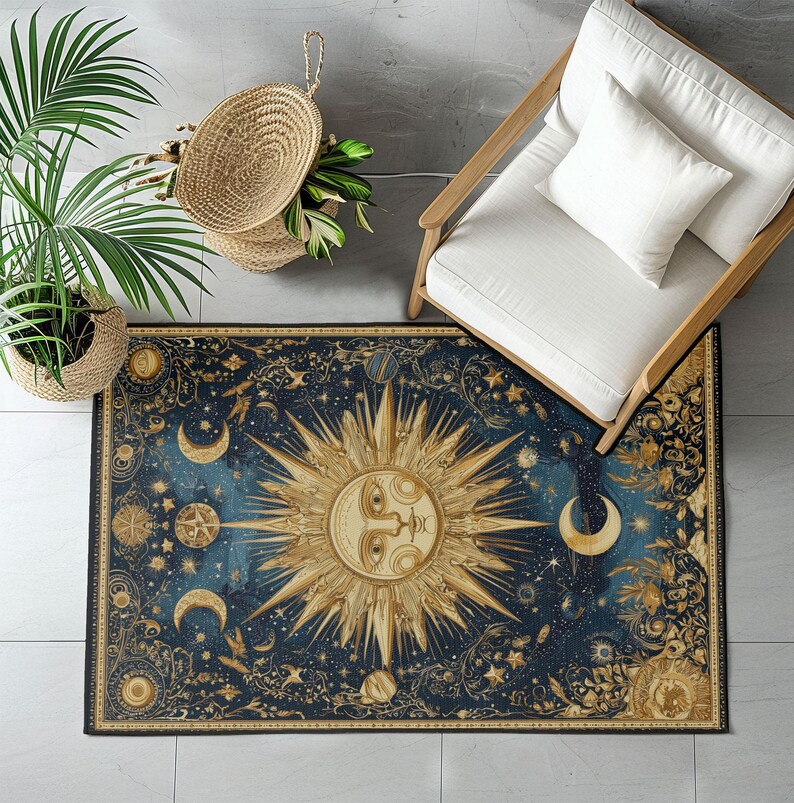 May include: A rectangular rug with a celestial design featuring a large sun, crescent moons, stars, and planets in shades of gold and cream against a dark blue background. The rug is bordered with an ornate gold pattern.