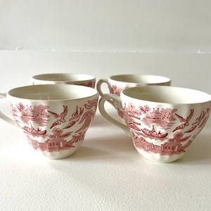 May include: A set of three ceramic vases in varying sizes and shapes. The vases are glazed in a matte white finish, with a textured surface. The tallest vase is approximately 10 inches tall.
