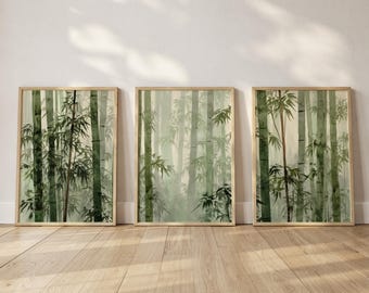 Könnte beinhalten: Drei gerahmte Aquarelldrucke eines Bambuswaldes in Grün- und Brauntönen. Das Kunstwerk zeigt hohe Bambusstämme und Blätter, die eine ruhige Szene schaffen. Die Rahmen sind hellbraun.
