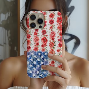 May include: A floral phone case featuring a design that resembles the American flag. The top half showcases red flowers on a white background, while the bottom half displays blue flowers with white stars.