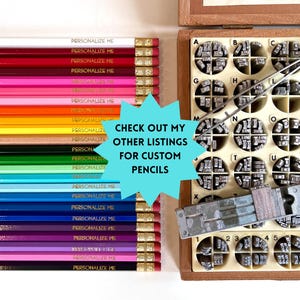 May include: A collection of multi-colored pencils arranged in a row, each featuring the text PERSONALIZE ME, alongside a wooden organizer box filled with metal letter stamps, a pair of metal tweezers, and a metal stamping tool for customization.
