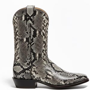 Può includere: Un singolo stivale da cowboy con un motivo a pelle di serpente nei toni del grigio, nero e bianco. Lo stivale ha una punta affilata, un tacco impilato e un gambale alto. Lo stivale è realizzato in pelle e ha un classico design Western.