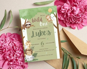 May include: A green and white invitation card with the text "Wild One" and "Luke's First birthday!" features illustrations of a sloth, monkey, giraffe, lion, and elephant. The invitation is surrounded by pink flowers and a brown envelope.