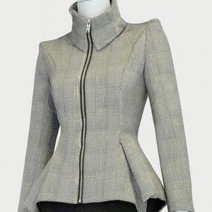 May include: A gray and white plaid jacket with a high collar and a black zipper. The jacket has long sleeves and a peplum waist. The jacket is displayed on a mannequin.