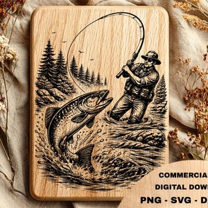 Könnte beinhalten: Ein rechteckiges Holzbrett mit einer schwarzen Lasergravur, die eine Person beim Angeln in einem Fluss mit einem großen springenden Fisch, Tannen und Vögeln zeigt. Der Text lautet ArtFlow Design, Commercial Use, Digital Download, PNG, SVG, DXF, EPS.
