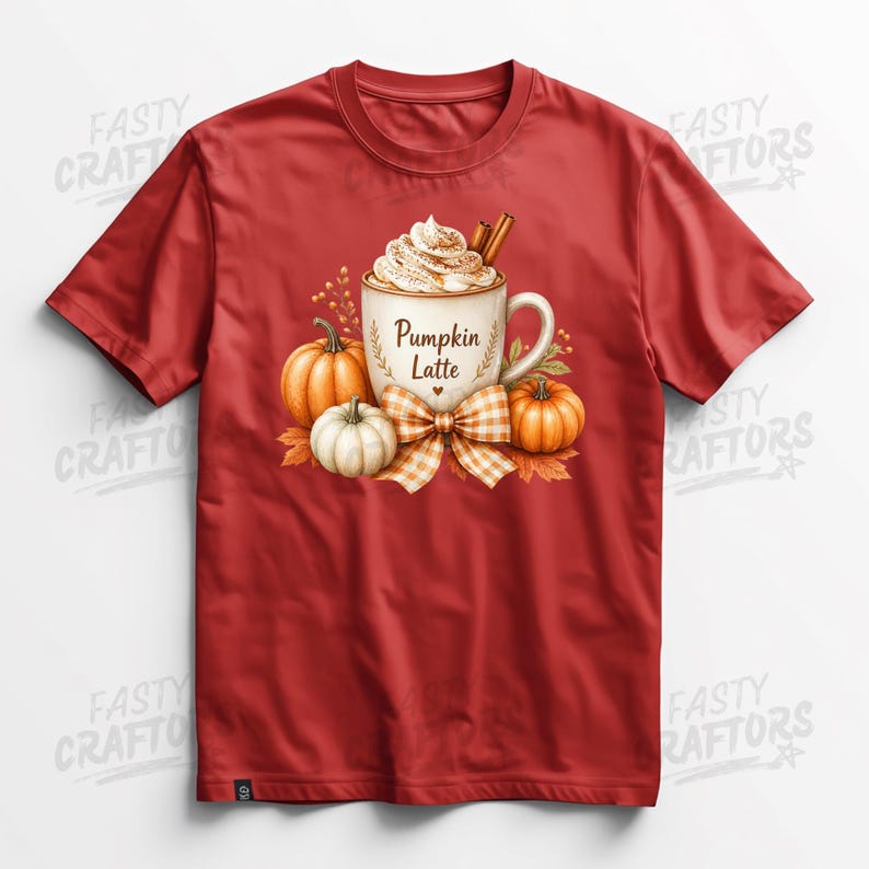 May include: A red short-sleeved t-shirt featuring a graphic of a mug filled with a pumpkin latte, topped with whipped cream and cinnamon sticks. The mug is labelled Pumpkin Latte and is surrounded by orange pumpkins and a plaid bow.