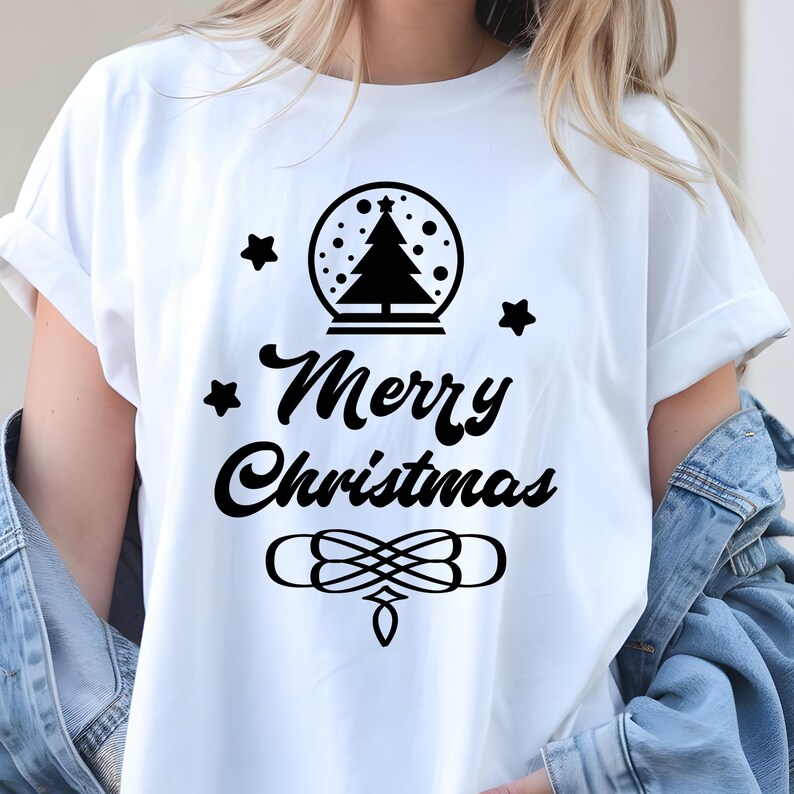 May include: White t-shirt with a black Christmas design. The design includes a snow globe with a Christmas tree, stars, and the words "Merry Christmas" in a decorative font. A festive holiday tee.